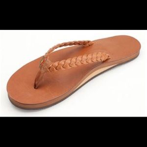 Rainbow braided leather flip flops in tan.